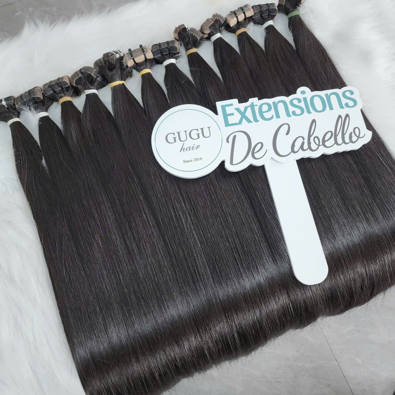 24 inch Vietnamese tape-in hair extensions in natural black color by GUGUHAIR